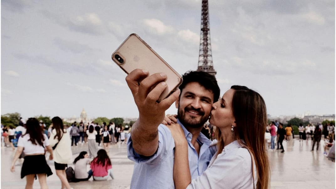 Eltern im Urlaub ohne Kinder Paar macht ein Selfie vor dem Eiffelturm