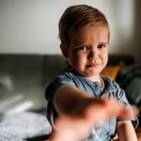 Ein Kleinkind weint und streckt den Arm aus. Ein Kleinkind weint und streckt den Arm aus.