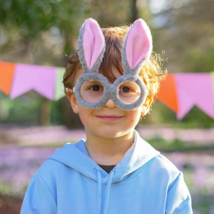 "Wie, den Osterhasen gibt es nicht!?" Ein kleiner Junge mit einer Osterhasen-Brille.
