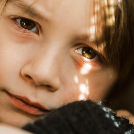 Dunkle Augenringe sind bei Kindern nur selten ein Grund zur Sorge. Eine Junge mit roten Augenringen