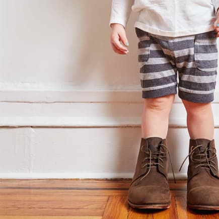 Wo finde ich die besten Secondhand-Schätze für meine Kinder? Kleinkind mit viel zu großen Schuhen.